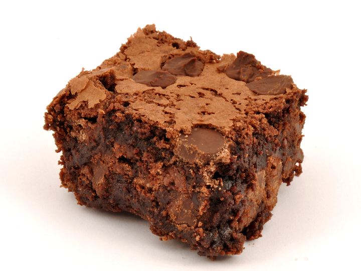 A single fudgy chocolate brownie with chocolate chunks